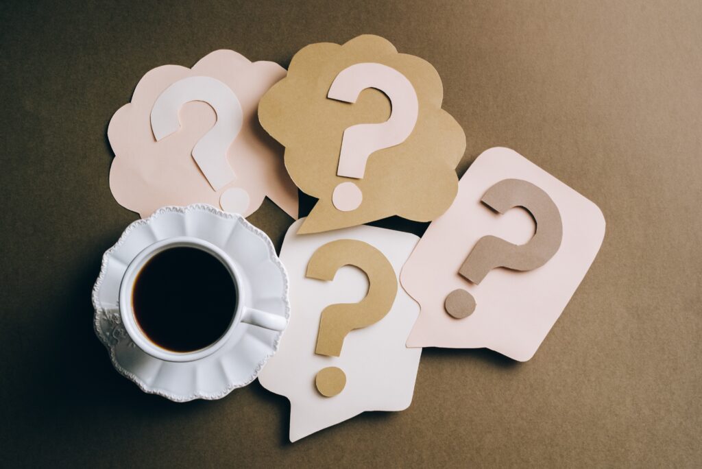 Question Marks and Coffee Cup